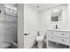 Contemporary bathroom featuring shower with marble tile, a vanity, and modern fixtures at 3716 W 16Th St, Indianapolis, IN 46222