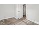 Bright bedroom featuring modern vinyl plank flooring, baseboards, and a double closet at 3716 W 16Th St, Indianapolis, IN 46222
