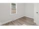 Cozy bedroom featuring modern vinyl plank flooring, a window, and a closet at 3716 W 16Th St, Indianapolis, IN 46222