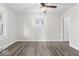 Spacious bedroom with neutral walls, ceiling fan, and wood-look flooring at 3716 W 16Th St, Indianapolis, IN 46222
