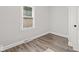 Bright bedroom featuring modern flooring and a freshly painted clean, neutral color palette with a window at 3716 W 16Th St, Indianapolis, IN 46222