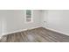 Neutral bedroom with modern vinyl plank flooring, a window, and a closet at 3716 W 16Th St, Indianapolis, IN 46222