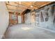Garage with plywood ceiling and walls with exposed insulation, offering plenty of storage and workspace at 3716 W 16Th St, Indianapolis, IN 46222