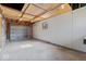Clean garage featuring a rolling garage door, smooth gray flooring and bright lighting at 3716 W 16Th St, Indianapolis, IN 46222
