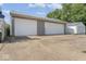 Two car garage with paved driveway and partial view of shed at 3716 W 16Th St, Indianapolis, IN 46222