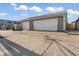 Exterior view of a two-car garage with concrete driveway and gray siding at 3716 W 16Th St, Indianapolis, IN 46222