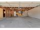 Spacious garage with exposed beams, unfinished walls, and concrete flooring, ready for customization at 3716 W 16Th St, Indianapolis, IN 46222