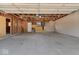 Unfinished two-car garage with visible studs, rafters, and a concrete floor at 3716 W 16Th St, Indianapolis, IN 46222