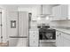 Well-equipped kitchen featuring stainless steel appliances, gray countertops, and white cabinetry at 3716 W 16Th St, Indianapolis, IN 46222
