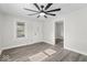 Airy living room with wood-look floors, neutral walls, and a door leading outside at 3716 W 16Th St, Indianapolis, IN 46222