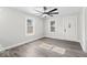 Sun-drenched living room featuring gray flooring, a modern ceiling fan, and two windows at 3716 W 16Th St, Indianapolis, IN 46222