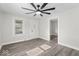 Inviting living room with gray flooring, two windows, and a modern ceiling fan at 3716 W 16Th St, Indianapolis, IN 46222