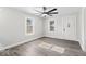 Bright living room featuring wood-look floors, modern ceiling fan, and ample natural light at 3716 W 16Th St, Indianapolis, IN 46222