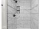 Close-up of stylish marble tile shower and modern fixtures at 3716 W 16Th St, Indianapolis, IN 46222