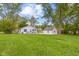 Spacious lawn highlights the layout, featuring a home with a front porch and detached garage at 425 Patterson Rd, Columbus, IN 47203