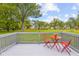 Backyard features a deck with a red table and chairs and a view of the yard at 425 Patterson Rd, Columbus, IN 47203