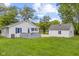 View of house and garage from backyard with grass at 425 Patterson Rd, Columbus, IN 47203