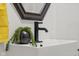 Close-up of bathroom vanity with a sleek, modern faucet, black hardware, and a decorative plant at 425 Patterson Rd, Columbus, IN 47203