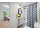 Bathroom features a modern vanity with sink and a shower/tub with a blue patterned curtain at 425 Patterson Rd, Columbus, IN 47203