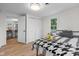 Bedroom featuring bright natural light, wood-look floors, and stylish black and white bedding at 425 Patterson Rd, Columbus, IN 47203