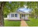 Charming home featuring blue shutters, well-maintained lawn, and inviting front porch at 425 Patterson Rd, Columbus, IN 47203