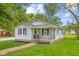 Attractive home with blue shutters and a cozy front porch, enhanced by lush green lawn at 425 Patterson Rd, Columbus, IN 47203