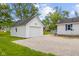 Detached one car garage with gravel driveway and view of the house at 425 Patterson Rd, Columbus, IN 47203