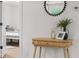 Hallway table featuring decoratively framed photos and a decorative mirror at 425 Patterson Rd, Columbus, IN 47203