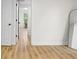 Hallway view with wood floor and open doors, with view to a room at 425 Patterson Rd, Columbus, IN 47203