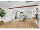 A wide view of the kitchen and living space with an open layout, wood floors, island seating, and natural light at 425 Patterson Rd, Columbus, IN 47203