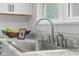 Close-up of a sink featuring modern faucet, and granite counter top at 425 Patterson Rd, Columbus, IN 47203