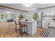 Bright, open kitchen features an island with granite countertops and seating, stainless steel appliances, and wood-look floors at 425 Patterson Rd, Columbus, IN 47203