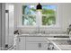 Modern sink with granite countertops and white cabinets, with a view of the outdoors at 425 Patterson Rd, Columbus, IN 47203