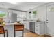 Renovated kitchen featuring white cabinets, stainless steel appliances, and marble countertops at 425 Patterson Rd, Columbus, IN 47203