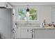 Close up of a remodeled kitchen with white cabinets, marble countertops, and a stainless steel refrigerator at 425 Patterson Rd, Columbus, IN 47203