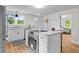Modern kitchen with stainless steel oven, white cabinets, island and marble countertop at 425 Patterson Rd, Columbus, IN 47203