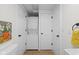 Bright laundry room features a stacked washer and dryer and a door to a closet at 425 Patterson Rd, Columbus, IN 47203