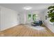 Open-concept living area with hardwood floors, a stylish blue chair, and plenty of natural light at 425 Patterson Rd, Columbus, IN 47203
