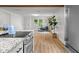 The open-concept living space has wood-look flooring, stainless steel appliances, and access to the dining area at 425 Patterson Rd, Columbus, IN 47203