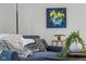 Stylish blue armchair with throw blanket and pillows, accented by modern decor and art at 425 Patterson Rd, Columbus, IN 47203
