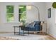 Cozy corner featuring a blue chair, stylish rug, and plenty of natural light from the windows at 425 Patterson Rd, Columbus, IN 47203