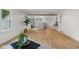 Spacious open area with hardwood floors, a kitchen, and an entryway, ideal for modern living at 425 Patterson Rd, Columbus, IN 47203