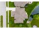 Aerial view of the property showcasing the roof, driveway, landscaping, and proximity to a pond at 4359 Prairie Falcon Dr, Zionsville, IN 46077