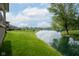 Serene backyard with a lush lawn, a picturesque lake, and a charming view of the neighboring houses at 4359 Prairie Falcon Dr, Zionsville, IN 46077