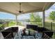 Relaxing covered patio with outdoor seating, a ceiling fan, and a beautiful view of the serene lake at 4359 Prairie Falcon Dr, Zionsville, IN 46077