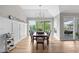Light-filled dining room with lake view, sliding door to porch, and stylish decor at 4359 Prairie Falcon Dr, Zionsville, IN 46077