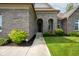 Arched entryway with landscaped front yard and well-manicured bushes at 4359 Prairie Falcon Dr, Zionsville, IN 46077