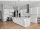 Modern kitchen featuring stainless steel appliances, a large island, and white cabinetry at 4359 Prairie Falcon Dr, Zionsville, IN 46077