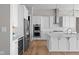 Modern kitchen featuring stainless steel appliances, quartz countertops, and custom white cabinetry at 4359 Prairie Falcon Dr, Zionsville, IN 46077