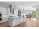 Gourmet kitchen with a large island, stainless steel appliances, and a view of the scenic backyard at 4359 Prairie Falcon Dr, Zionsville, IN 46077